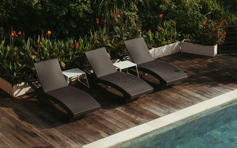 a group of chairs around a pool