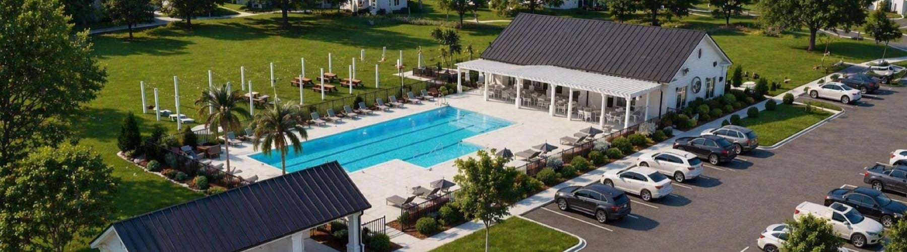 an aerial view of a pool and a parking lot with cars